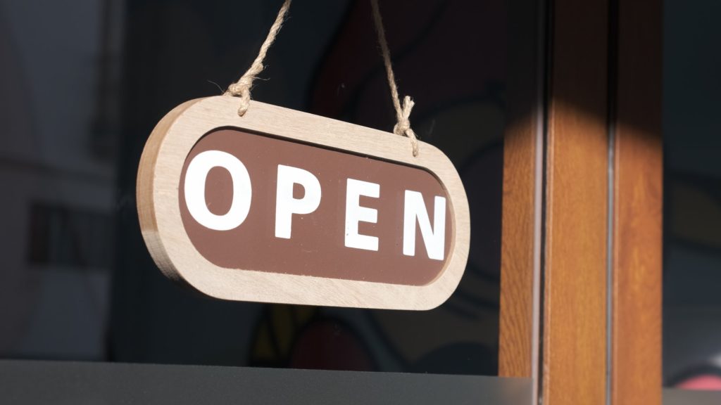 Small business opening up. Turning the sign to open